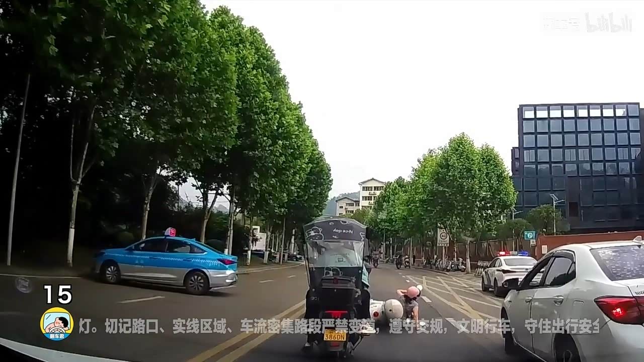 电动车带娃占道，假人横躺路中央